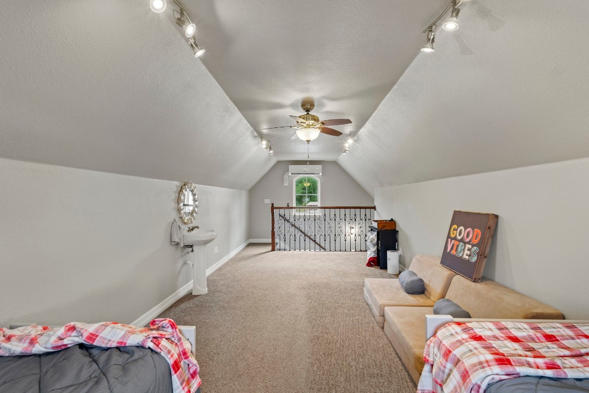 5535 Bearfoot Road Orange, TX 77632 - Photo 42 of 50 a bedroom with a bed and a chandelier