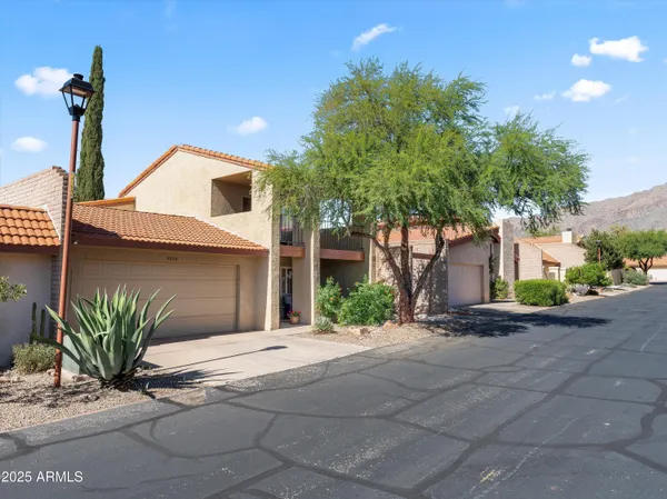 a front view of a house with a yard and a garage