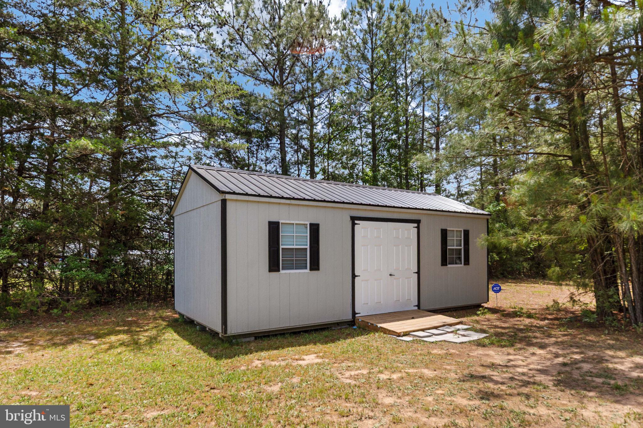 22088 Landora Bridge Road Ruther Glen, VA 22546 - Photo 112 of 122 Charming shed nestled in nature's embrace.