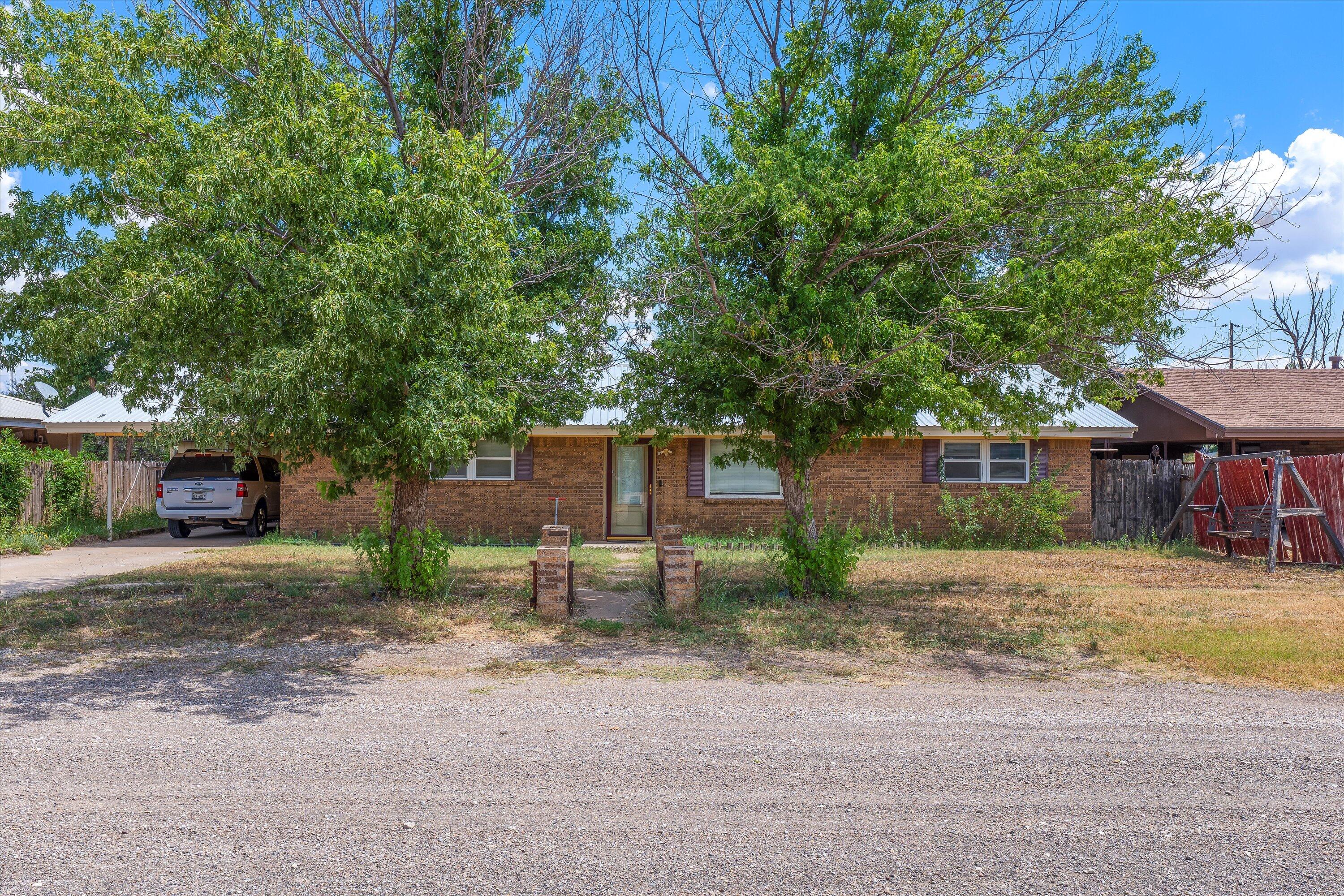 406 North Tyler Street Whiteface, TX 79346 - Photo 1 of 2 a view of a house with a yard and large tree