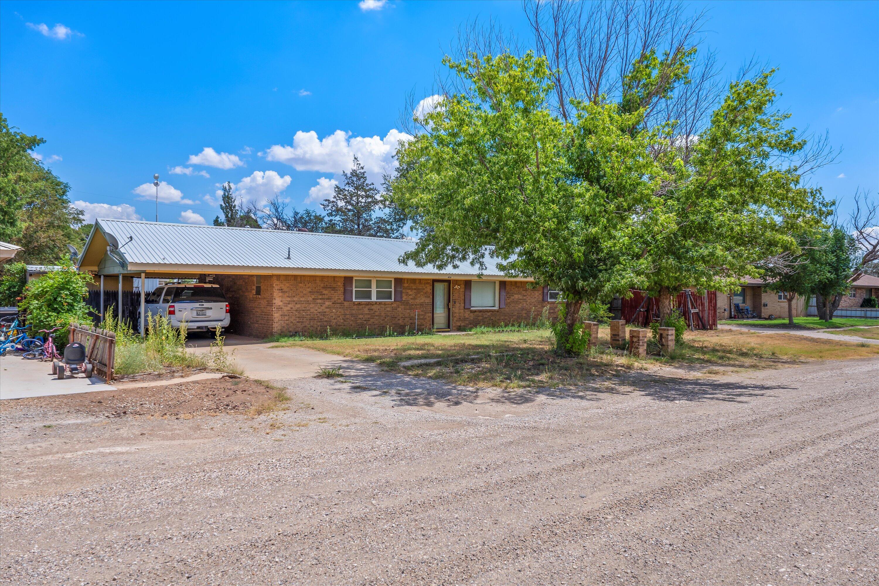 406 North Tyler Street Whiteface, TX 79346 - Photo 2 of 2 a front view of a house with a yard and a garage