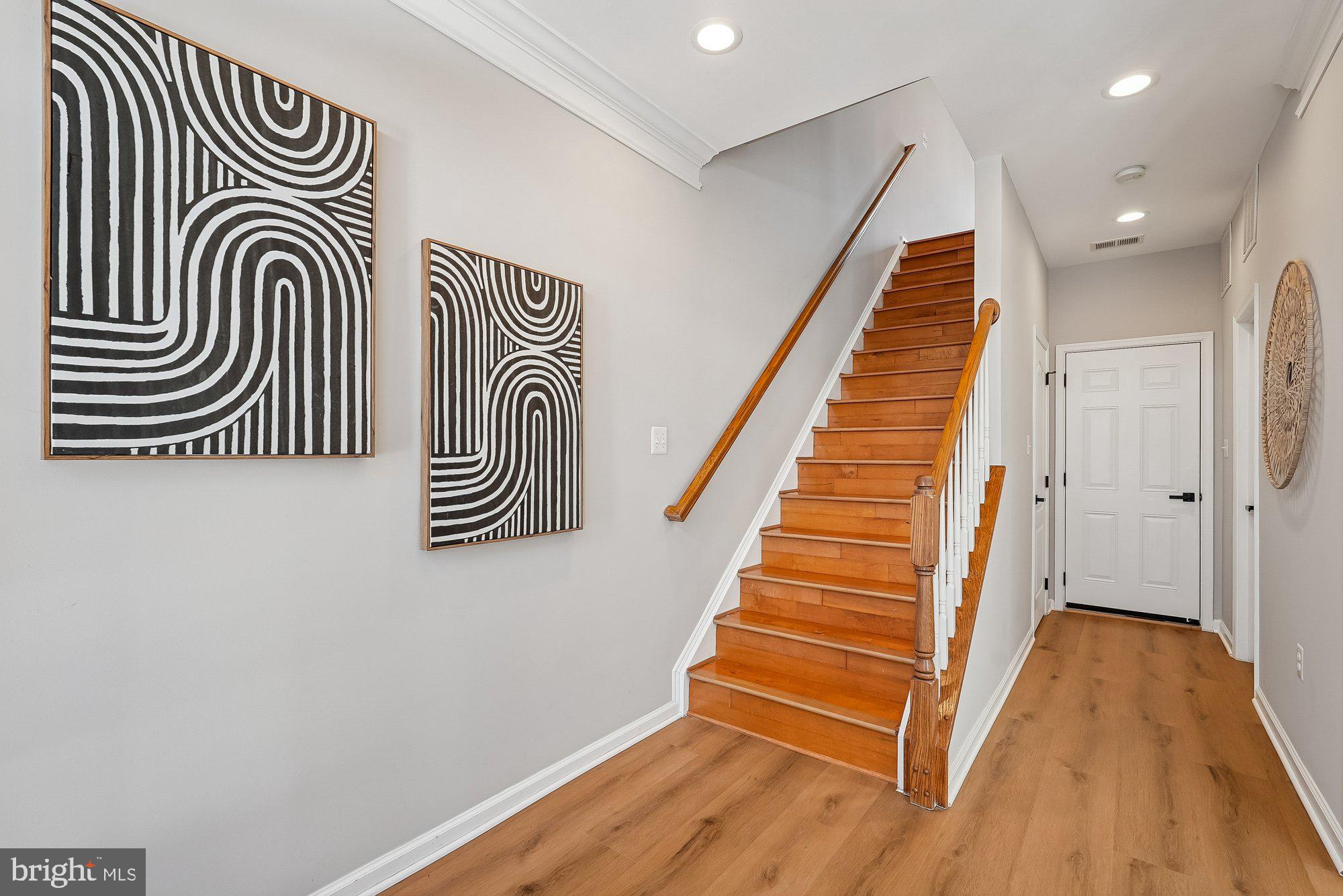 22982 Fox Fire Terrace Brambleton, VA 20148 - Photo 12 of 50 a view of a hallway with wooden floor and stairs