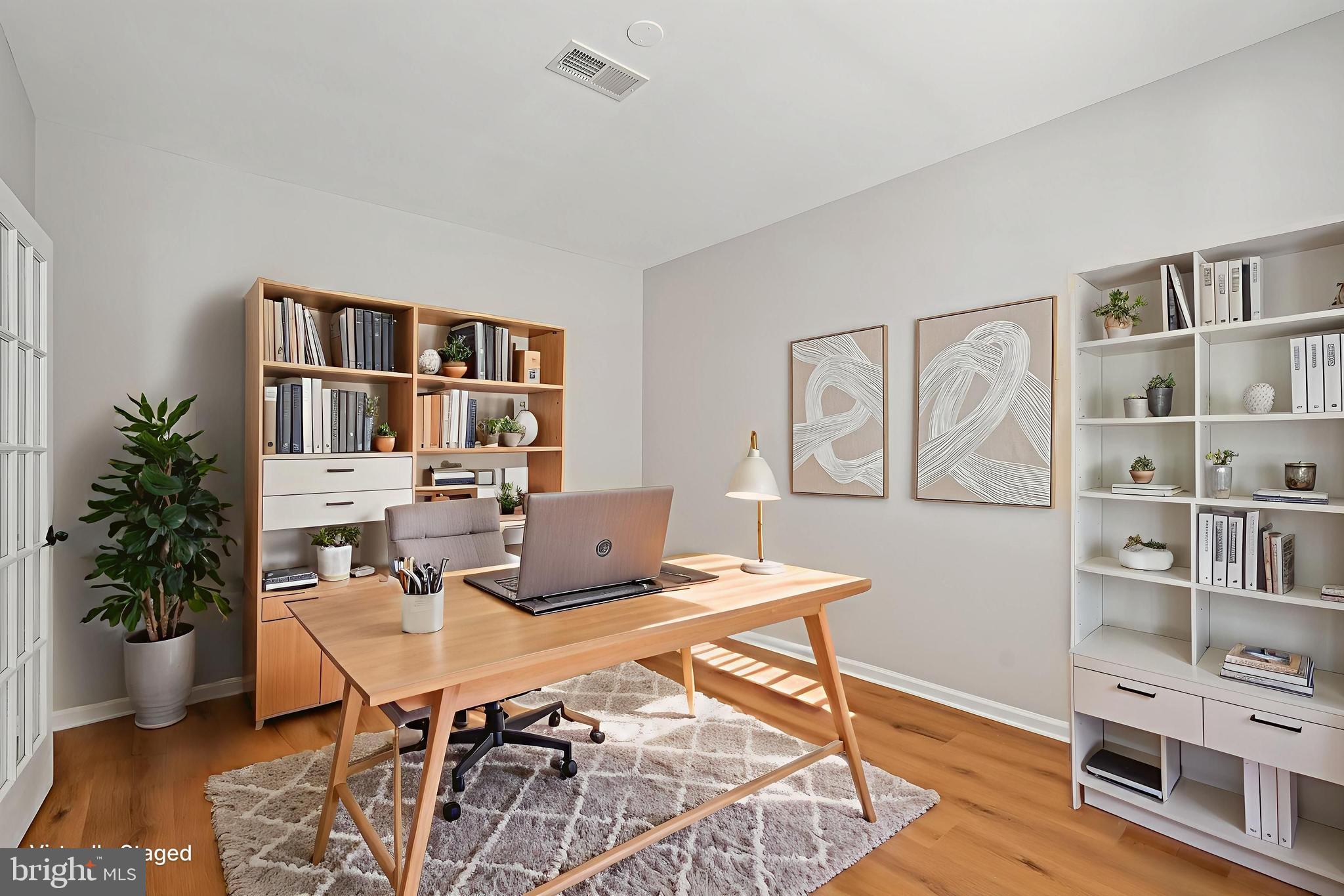 22982 Fox Fire Terrace Brambleton, VA 20148 - Photo 13 of 50 a workspace with furniture and bookshelf