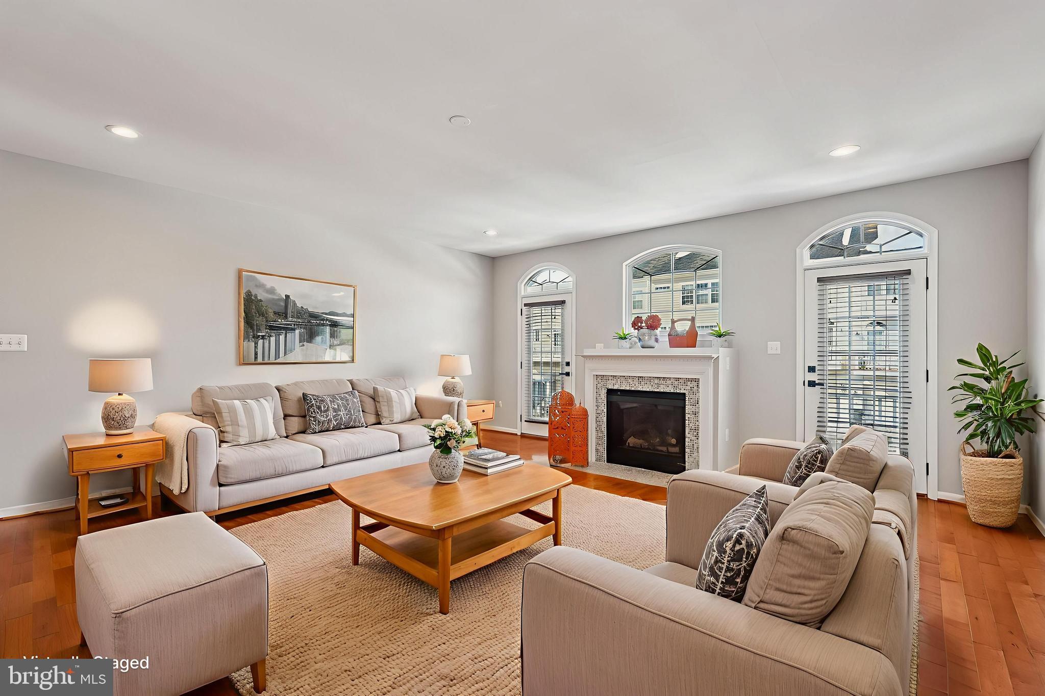 22982 Fox Fire Terrace Brambleton, VA 20148 - Photo 18 of 50 a living room with furniture and a fireplace