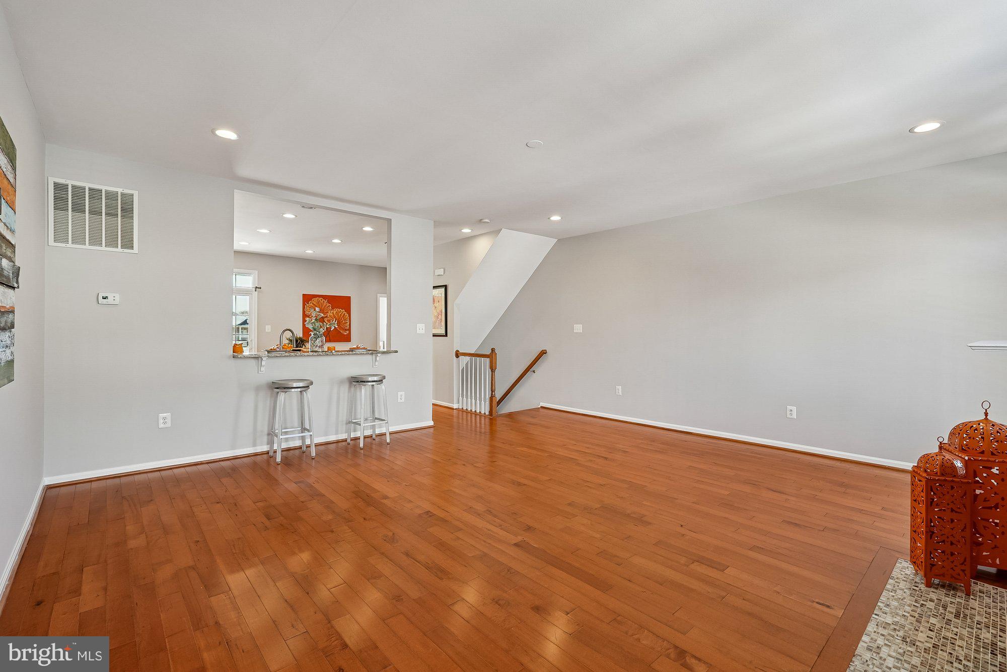 22982 Fox Fire Terrace Brambleton, VA 20148 - Photo 20 of 50 a room with a wooden floor and a large window