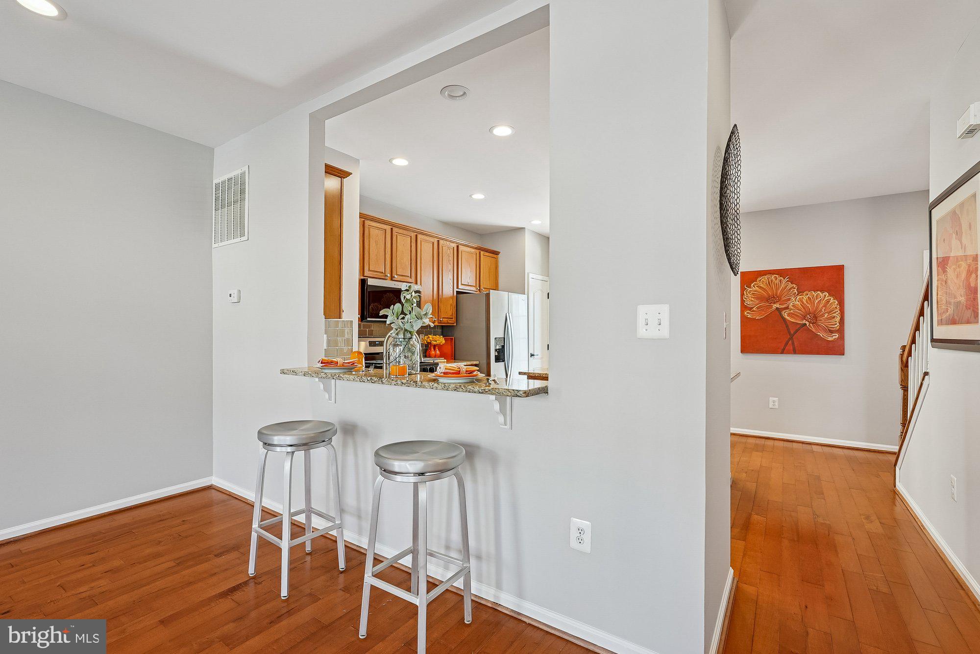 22982 Fox Fire Terrace Brambleton, VA 20148 - Photo 21 of 50 a view of a room with wooden floor furniture and windows
