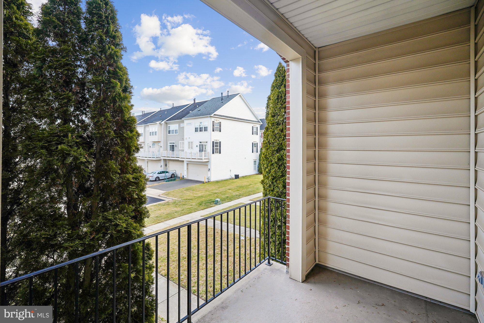 22982 Fox Fire Terrace Brambleton, VA 20148 - Photo 9 of 50 a view of a balcony with a tree