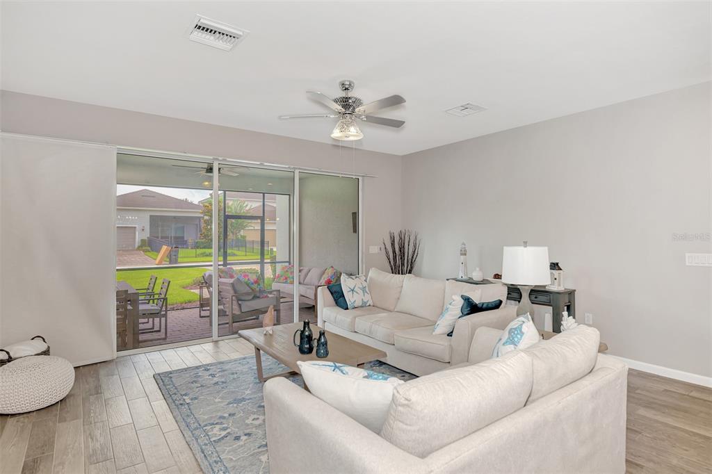 11616 Golden Bay Place Lakewood Ranch, FL 34211 - Photo 12 of 66 a living room with furniture and a table