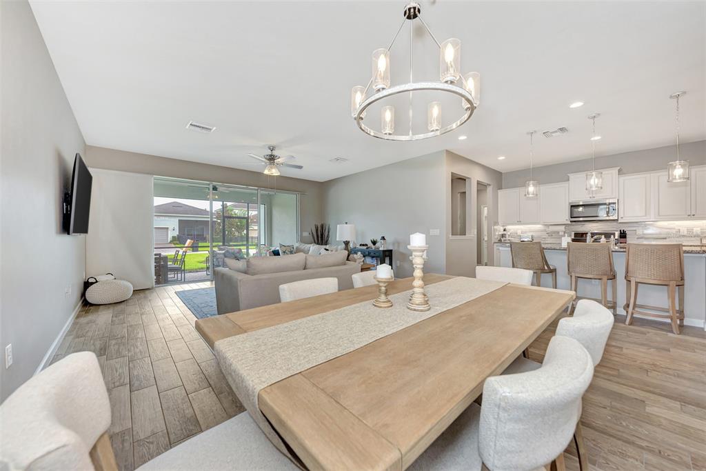 11616 Golden Bay Place Lakewood Ranch, FL 34211 - Photo 18 of 66 a view of a dining room with furniture