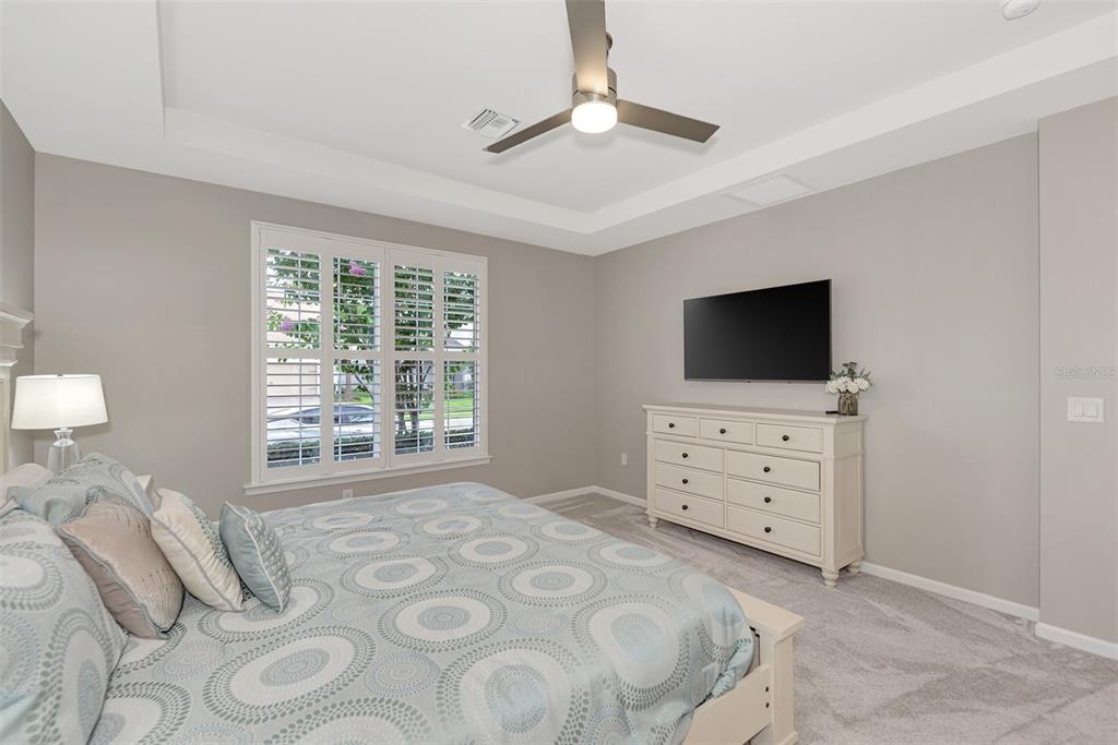 11616 Golden Bay Place Lakewood Ranch, FL 34211 - Photo 27 of 66 a bedroom with a bed and a flat screen tv