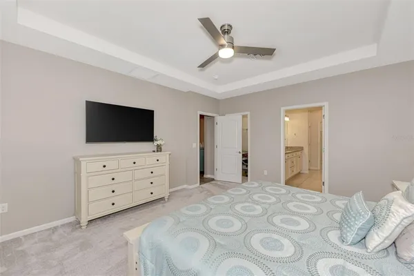 a spacious bathroom with a granite countertop sink a large mirror and a shower