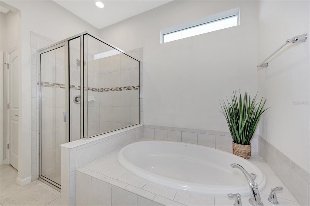 11616 Golden Bay Place Lakewood Ranch, FL 34211 - Photo 30 of 66 a bathroom with a bathtub and a shower