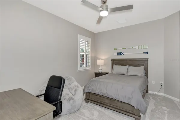 a bedroom with a bed window and a chair