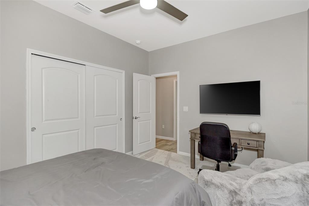 11616 Golden Bay Place Lakewood Ranch, FL 34211 - Photo 34 of 66 a bedroom with a bed and a flat screen tv