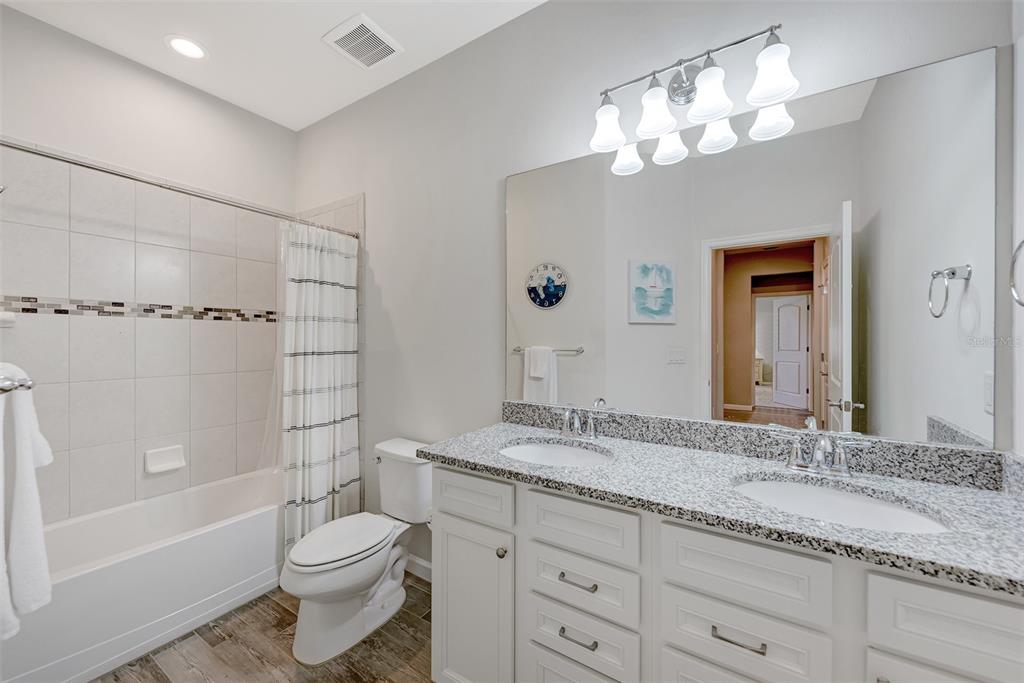11616 Golden Bay Place Lakewood Ranch, FL 34211 - Photo 35 of 66 a bathroom with a granite countertop sink a toilet and bathtub