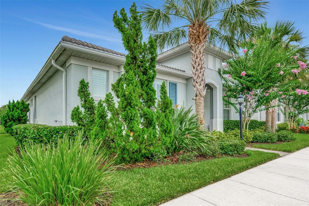 11616 Golden Bay Place Lakewood Ranch, FL 34211 - Photo 4 of 66 a front view of a house with a garden