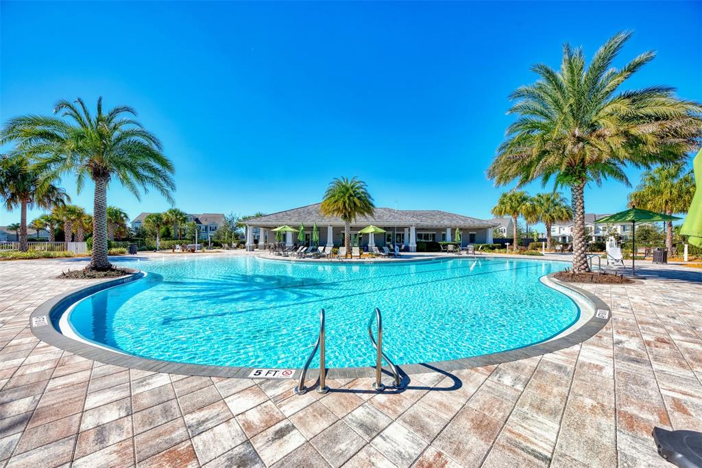 11616 Golden Bay Place Lakewood Ranch, FL 34211 - Photo 45 of 66 a view of a swimming pool with a garden