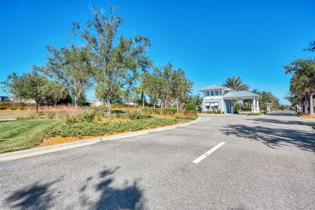 11616 Golden Bay Place Lakewood Ranch, FL 34211 - Photo 59 of 66 a front view of a house with a yard and garage