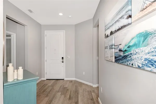 a view of a hallway to a livingroom with furniture