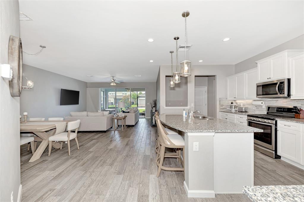 11616 Golden Bay Place Lakewood Ranch, FL 34211 - Photo 10 of 66 a large kitchen with a table and chairs