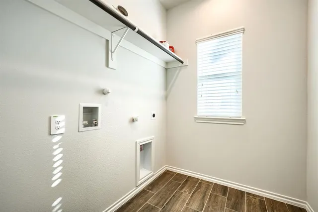 a view of a room with wooden floor and windows