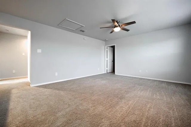 a view of a livingroom with a ceiling fan and window
