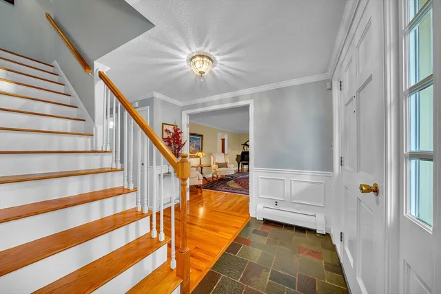 a view of a livingroom with wooden floor and staircase