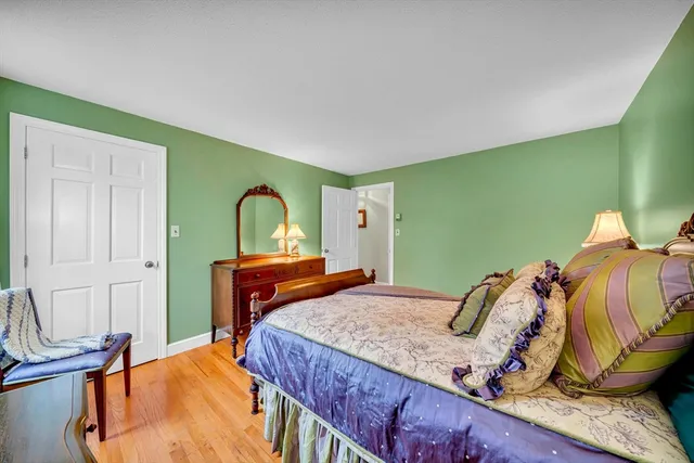 a bedroom with a bed and dresser