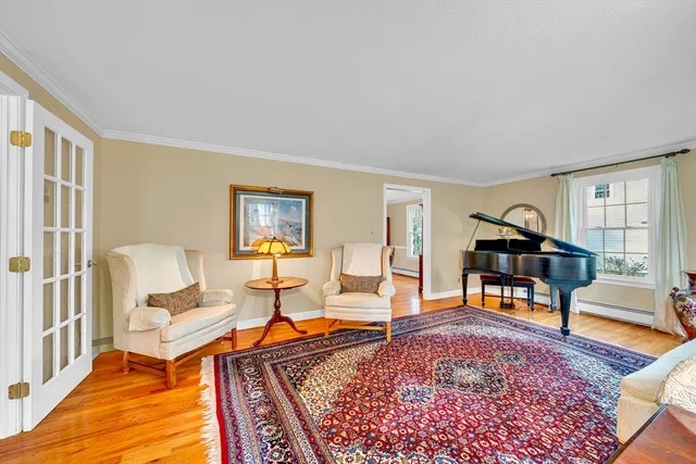 a living room with furniture a rug and a window