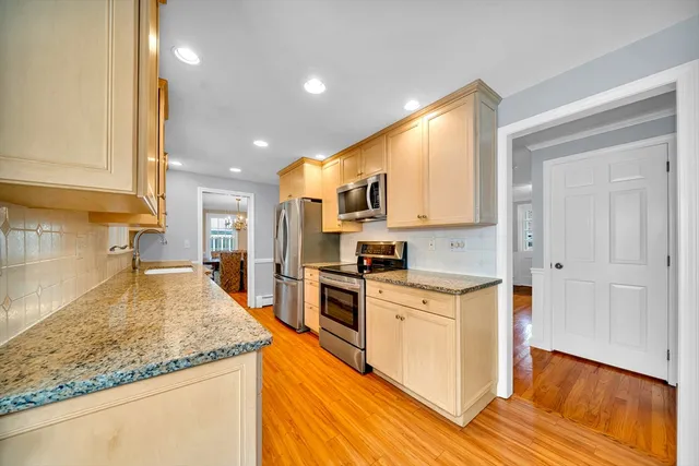 a kitchen with stainless steel appliances granite countertop a stove and a sink