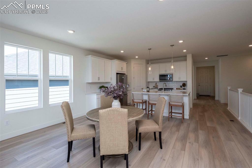 2036 Peachleaf Loop Castle Rock, CO 80108 - Photo 17 of 35 a dining room with furniture and wooden floor