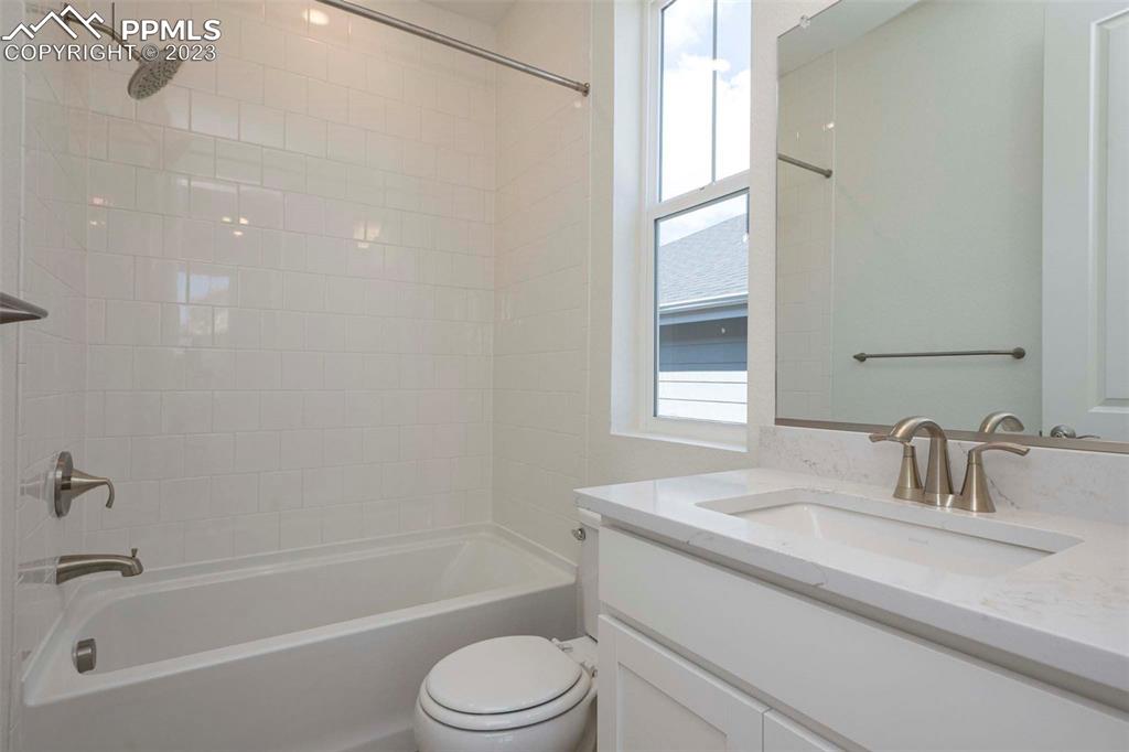 2036 Peachleaf Loop Castle Rock, CO 80108 - Photo 6 of 35 a bathroom with a granite countertop sink toilet and shower