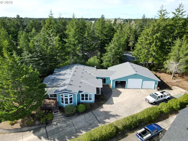 an aerial view of a house with a yard