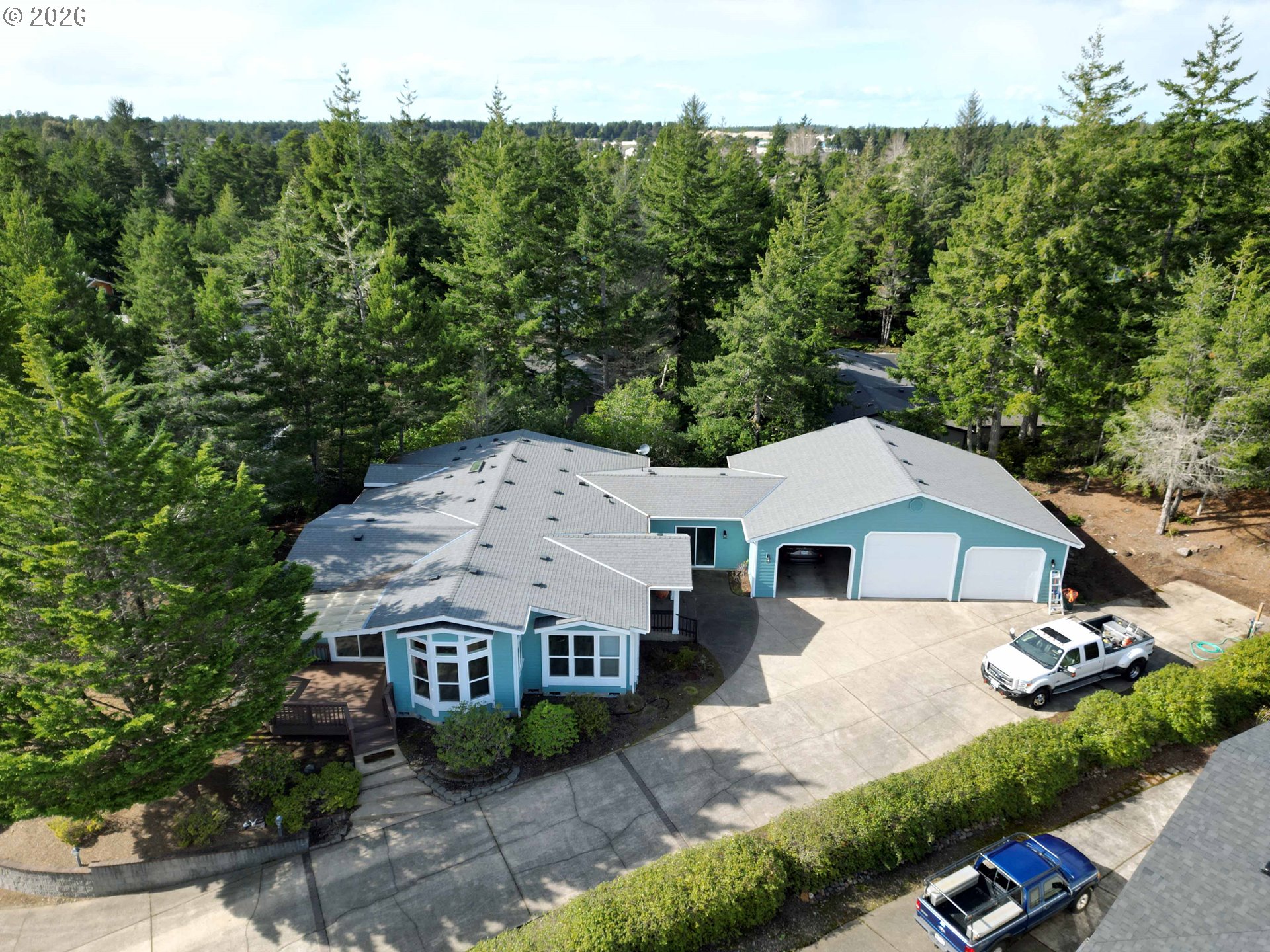 an aerial view of a house with a yard