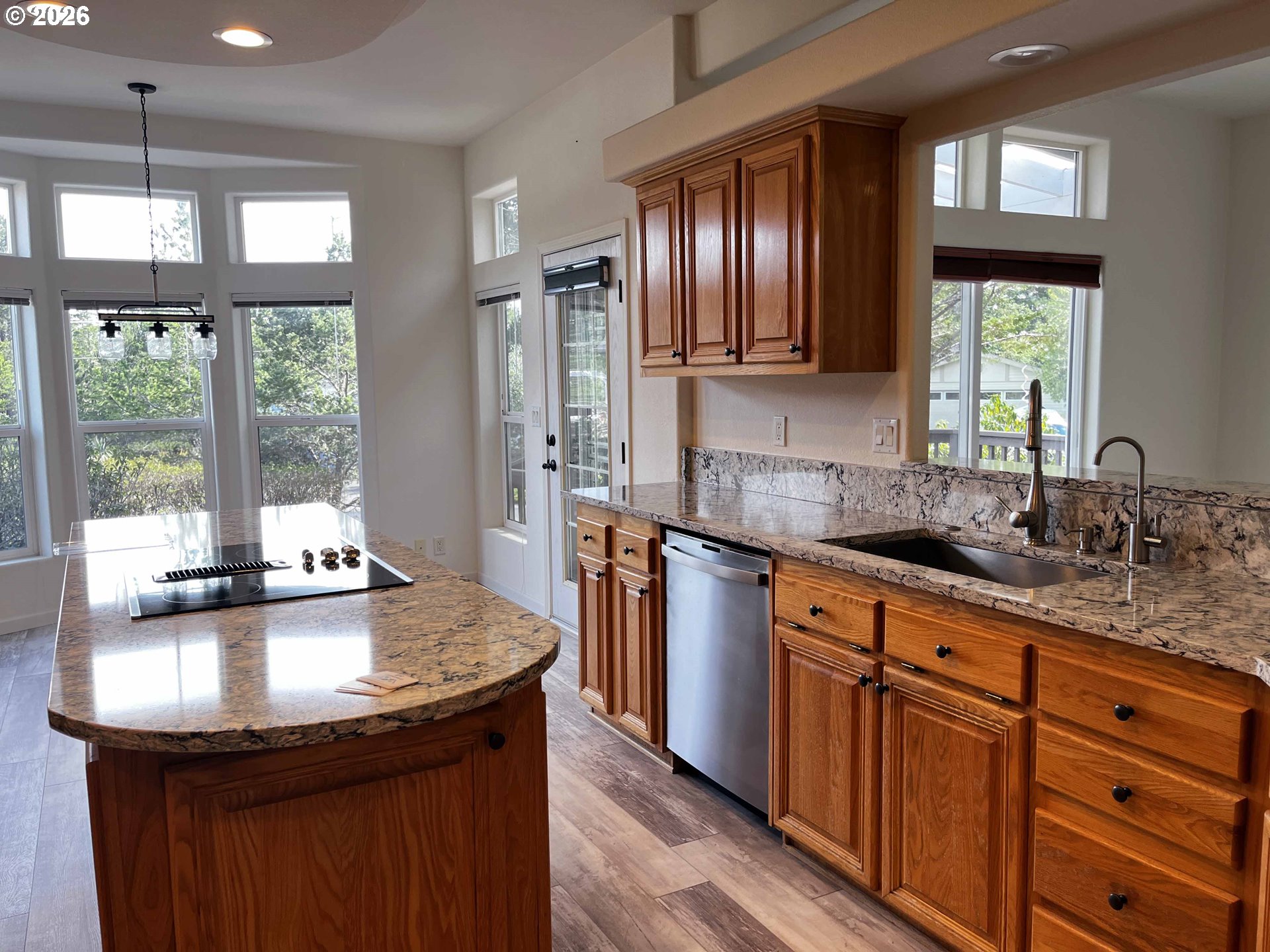 614 38th Place Florence, OR 97439 - Photo 14 of 48 a kitchen with stainless steel appliances granite countertop a sink a stove and a center island