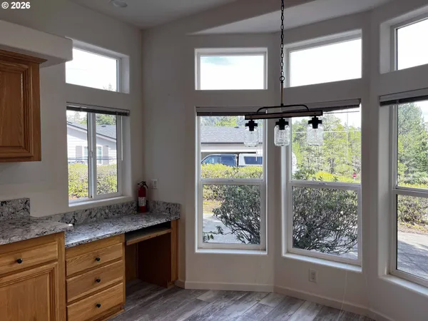 a bathroom with a granite countertop sink and large window