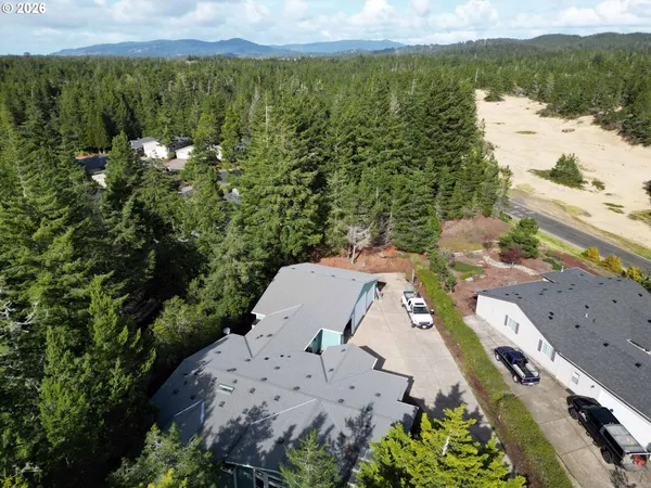 an aerial view of a house with a yard and lake view