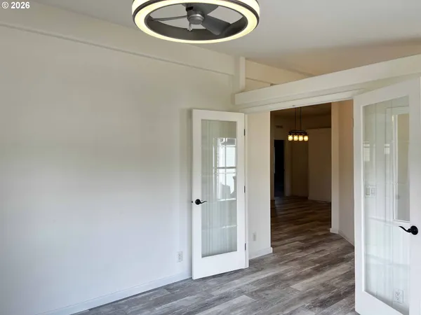 a view of a hallway with wooden floor