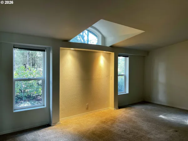 an empty room with windows and closet