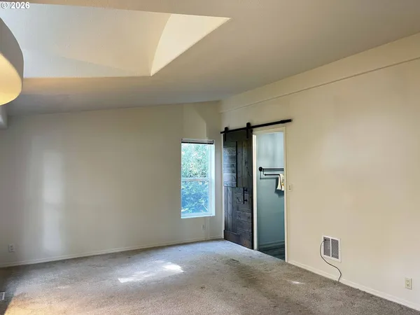 an empty room with windows and entrance