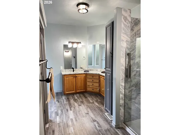 a bathroom with a sink a mirror and shower