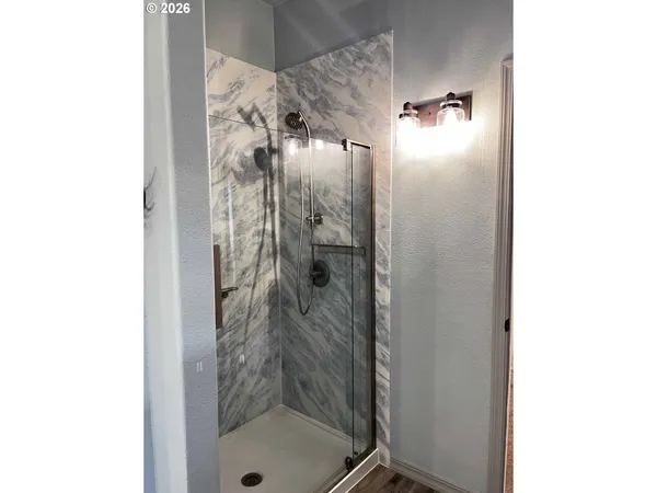 a bathroom with a glass shower door
