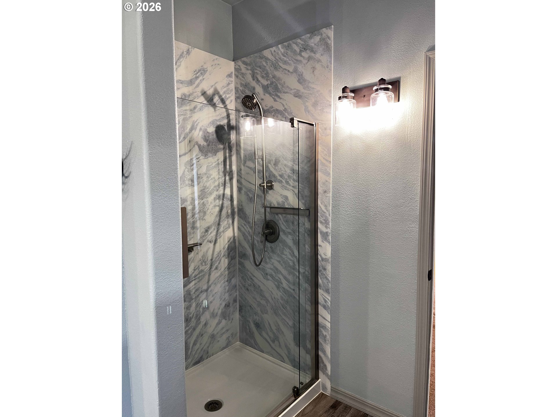 614 38th Place Florence, OR 97439 - Photo 28 of 48 a bathroom with a glass shower door