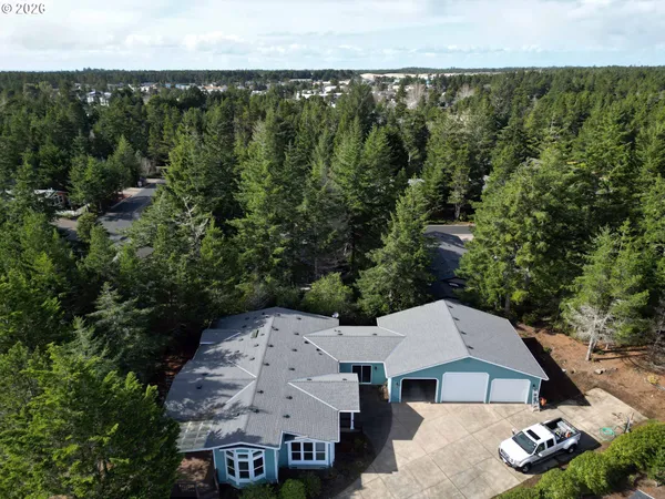 an aerial view of a house with garden space and street view