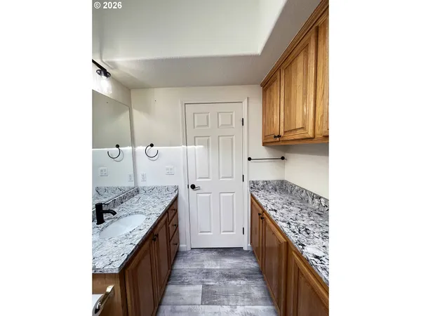 a kitchen with granite countertop a sink and cabinets