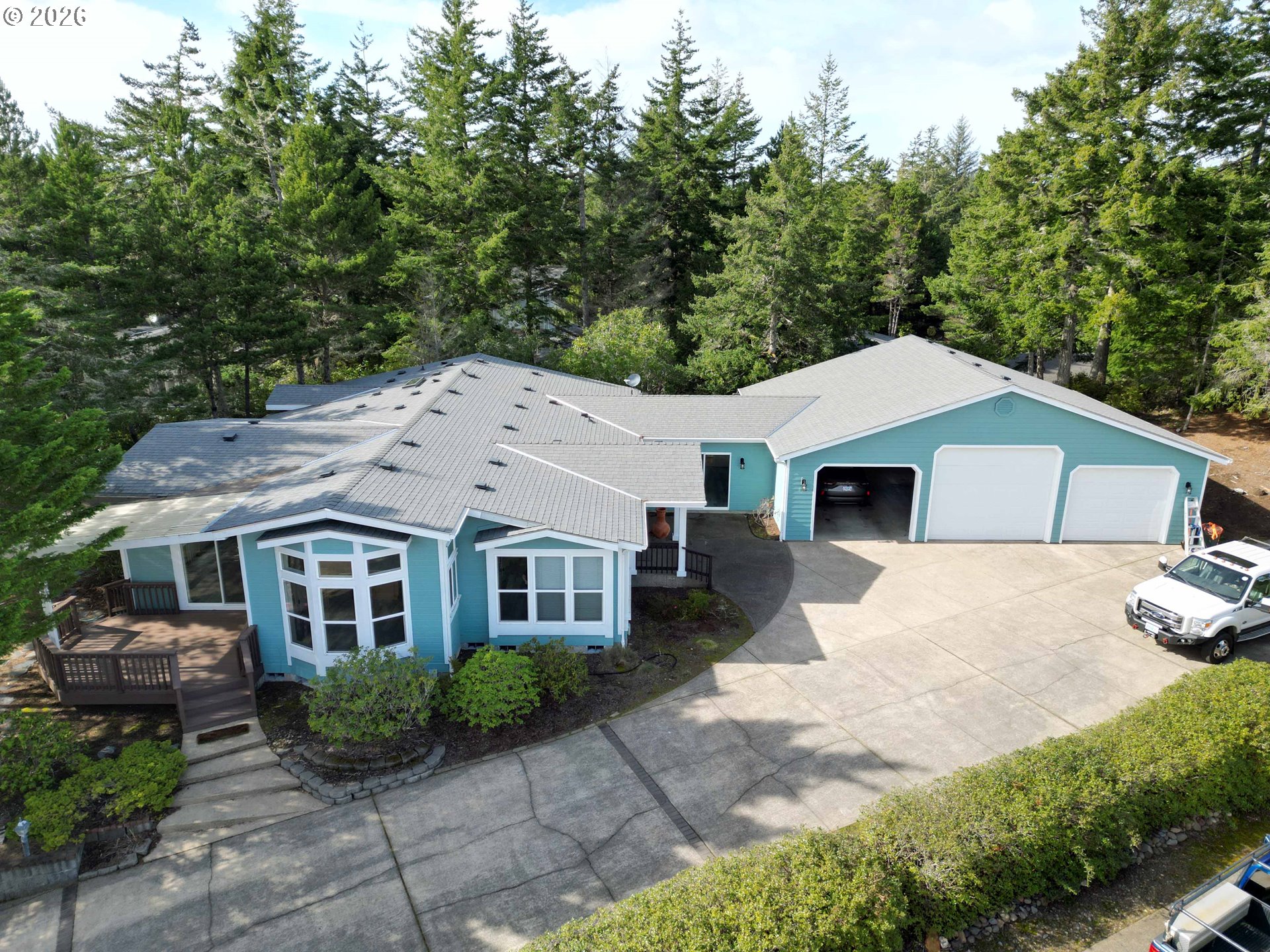 614 38th Place Florence, OR 97439 - Photo 4 of 48 a aerial view of a house with garden