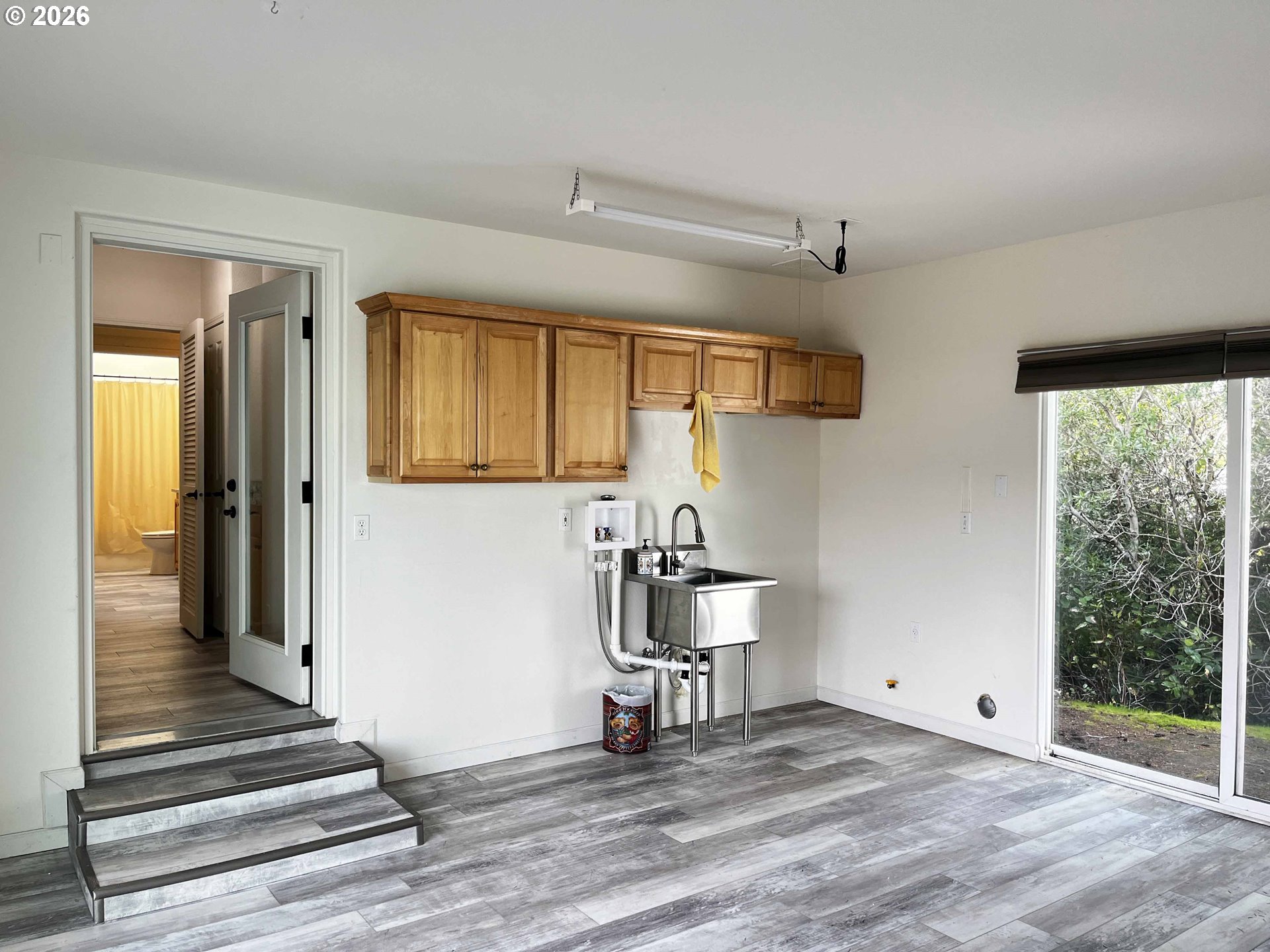 614 38th Place Florence, OR 97439 - Photo 44 of 48 a view of a hallway with wooden floor and staircase