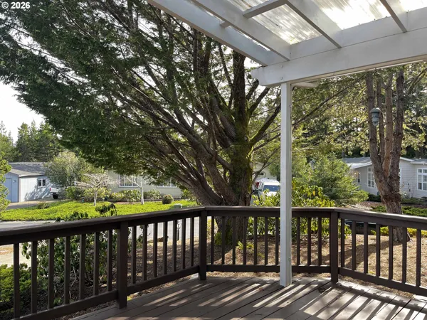 a balcony with wooden floor and furniture