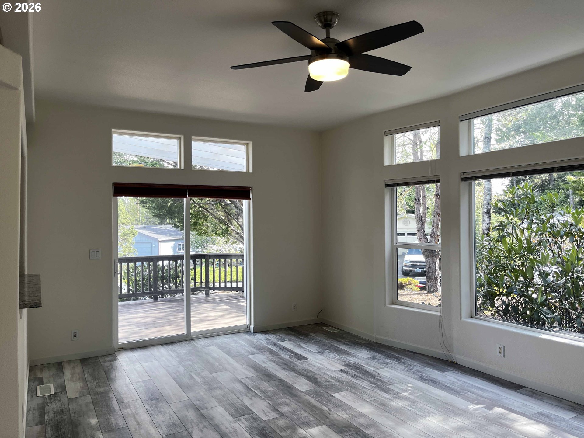 614 38th Place Florence, OR 97439 - Photo 10 of 48 wooden floor in an empty room with a window