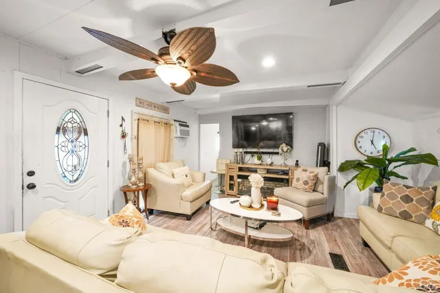 a living room with fireplace furniture and a flat screen tv